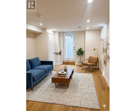 A living room with a blue couch, a wooden coffee table, and a rug.