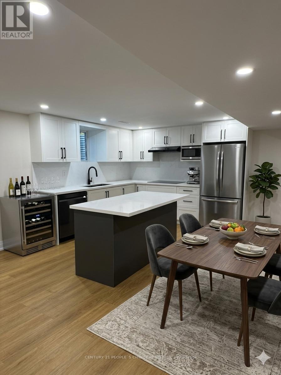 A modern kitchen with a dining table set for four.