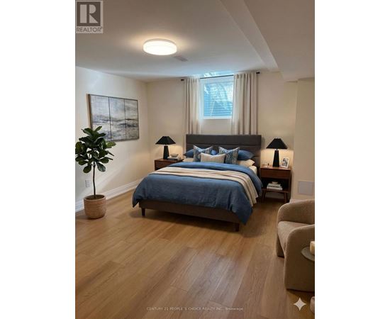 A bedroom with a bed, two lamps, a plant, and a painting on the wall.