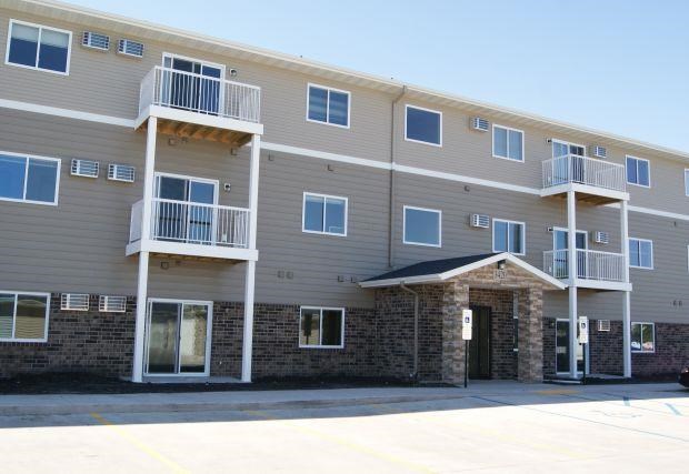 an apartment building with balconies and a front door