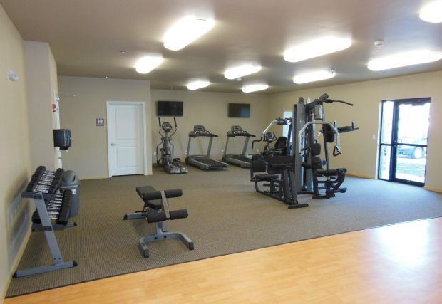 a gym with a lot of exercise equipment in it
