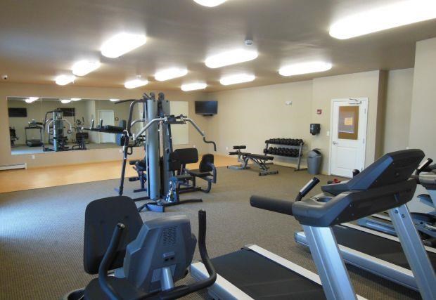 a gym with a lot of exercise equipment in it