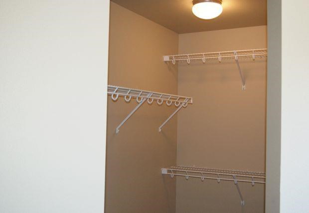 a bathroom with a closet and a hanging rack
