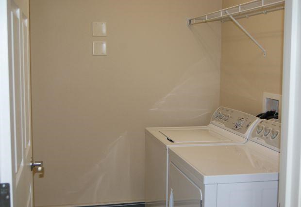 a white washer and dryer in a white room