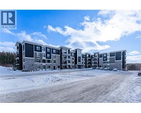 A large apartment complex with a REALTOR® logo in the corner.