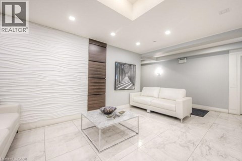 A modern living room with a white sofa and a glass coffee table.