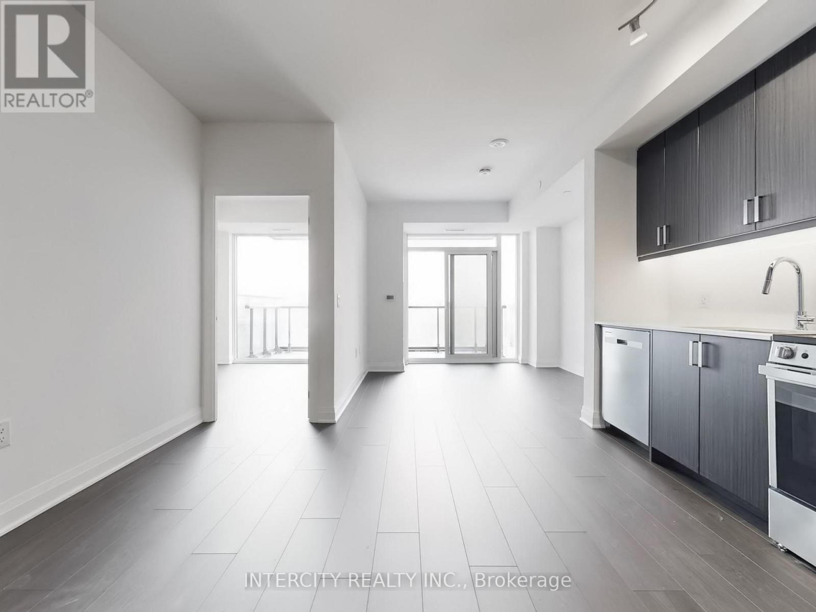 A spacious kitchen with a sink, stove, and oven is visible in the image.