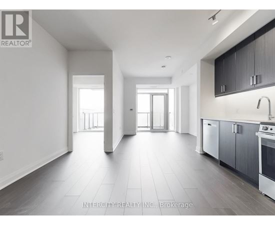 A spacious kitchen with a sink, stove, and oven is visible in the image.