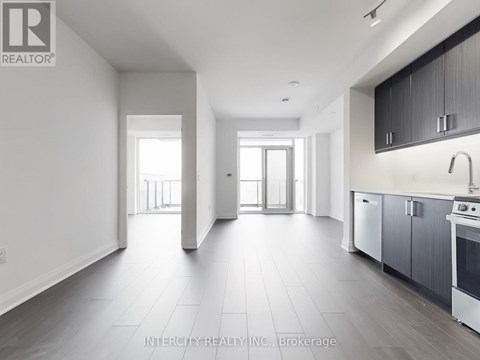 A spacious kitchen with a sink, stove, and oven is visible in the image.