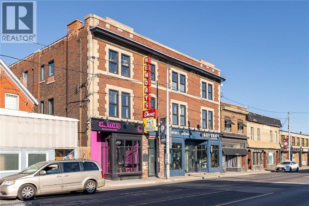 A street view with a building that has a sign that says "L.A. TITIES".