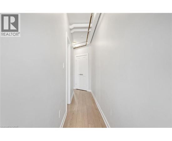 A long hallway with a door at the end.