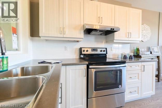 A kitchen with a stove and oven on top of a counter.