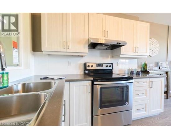 A kitchen with a stove and oven on top of a counter.