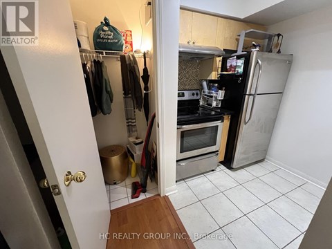 A kitchen with a refrigerator, stove, and oven.