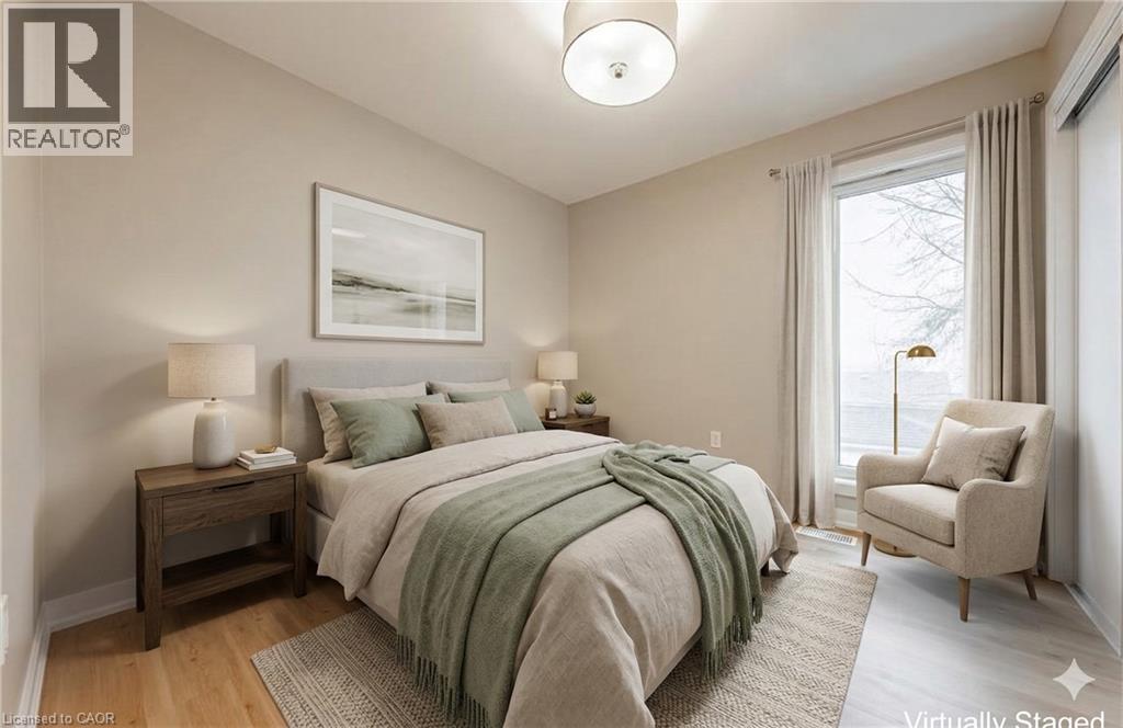 A bedroom with a bed, chair, and lamp.