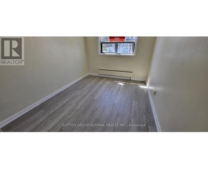 A room with a window and a radiator on the wall.