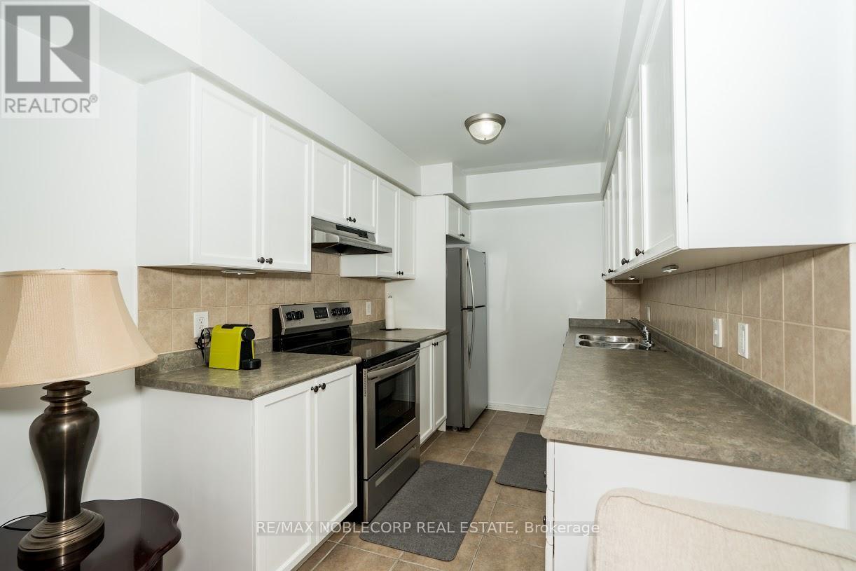 A kitchen with white cabinets and a counter top.