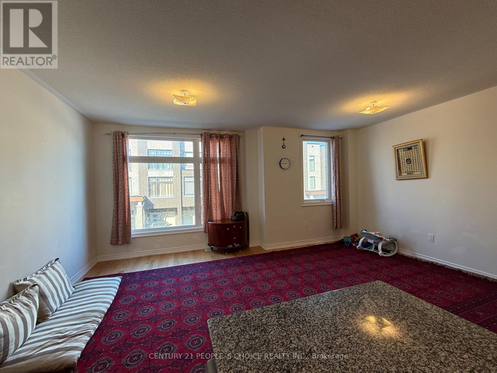 A bedroom with a large bed and a red carpet.