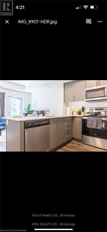 A modern kitchen with stainless steel appliances and a large island.
