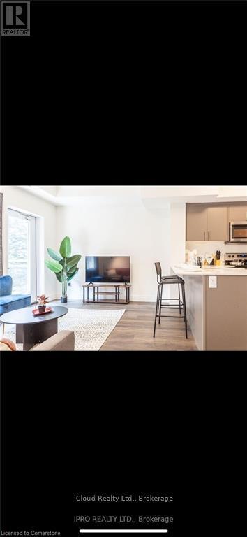 A modern living room with a sofa, a coffee table, and a TV.