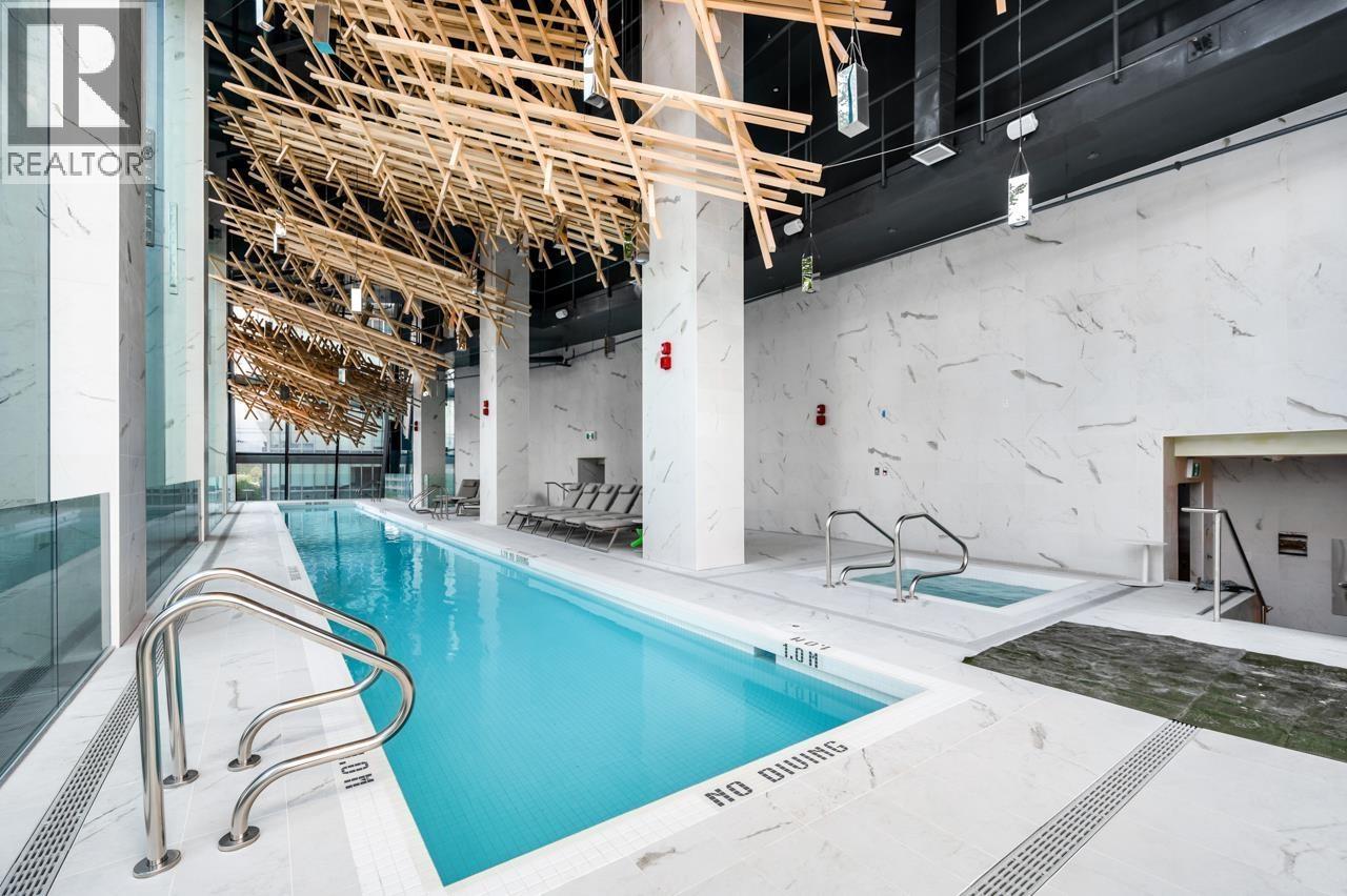 A large indoor swimming pool with a wooden structure above it.