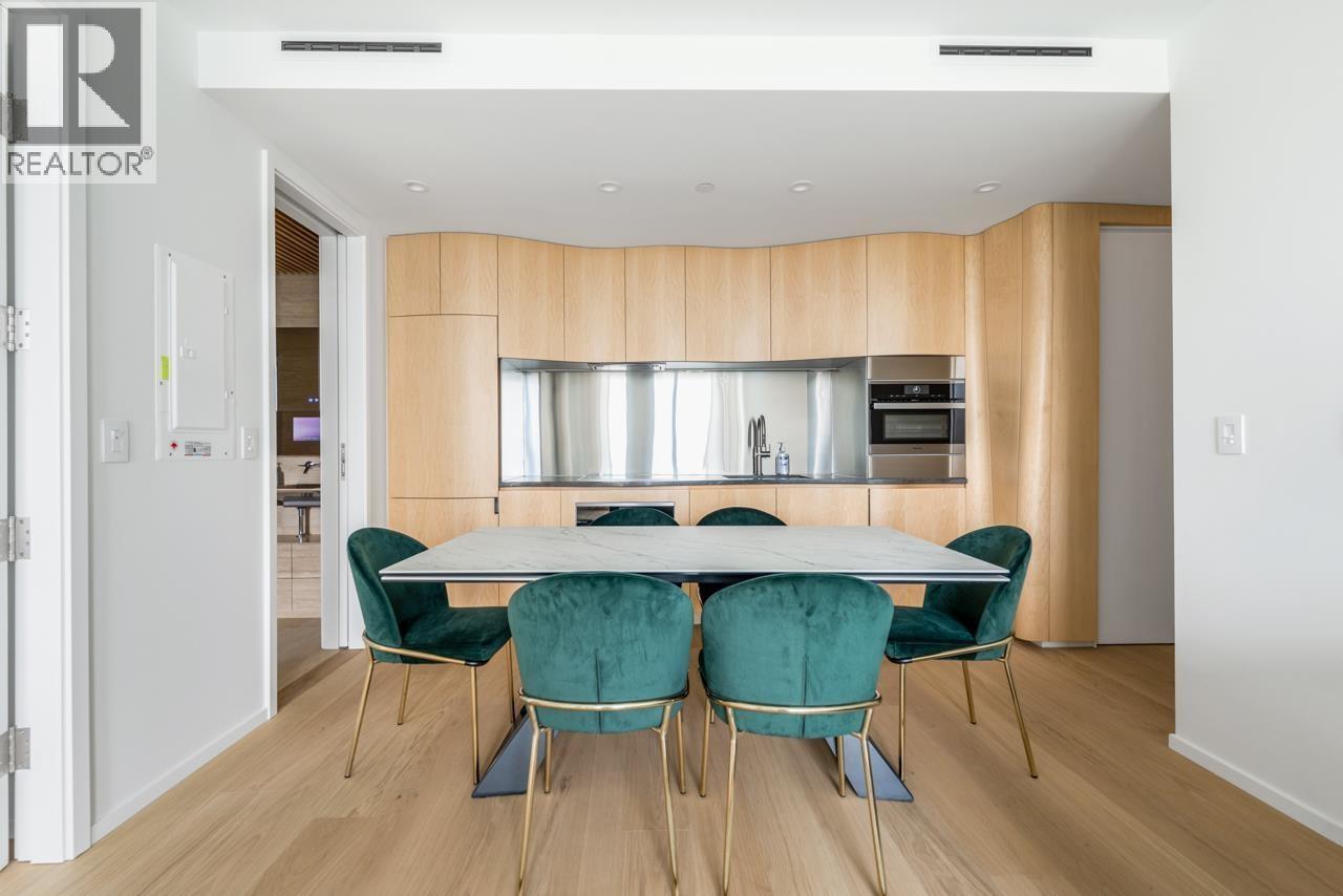 A dining room with a table set for four.