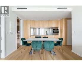 A dining room with a table set for four.