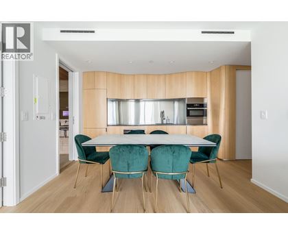 A dining room with a table set for four.