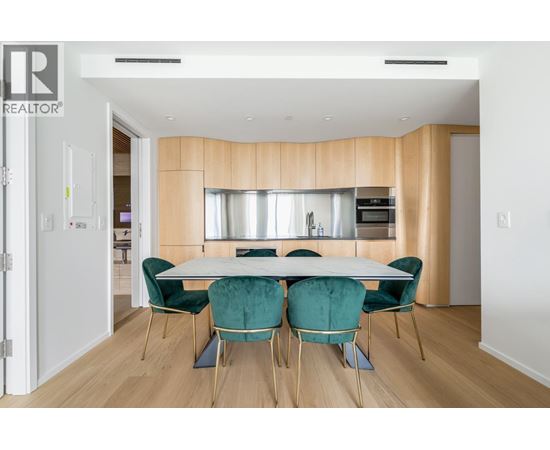 A dining room with a table set for four.