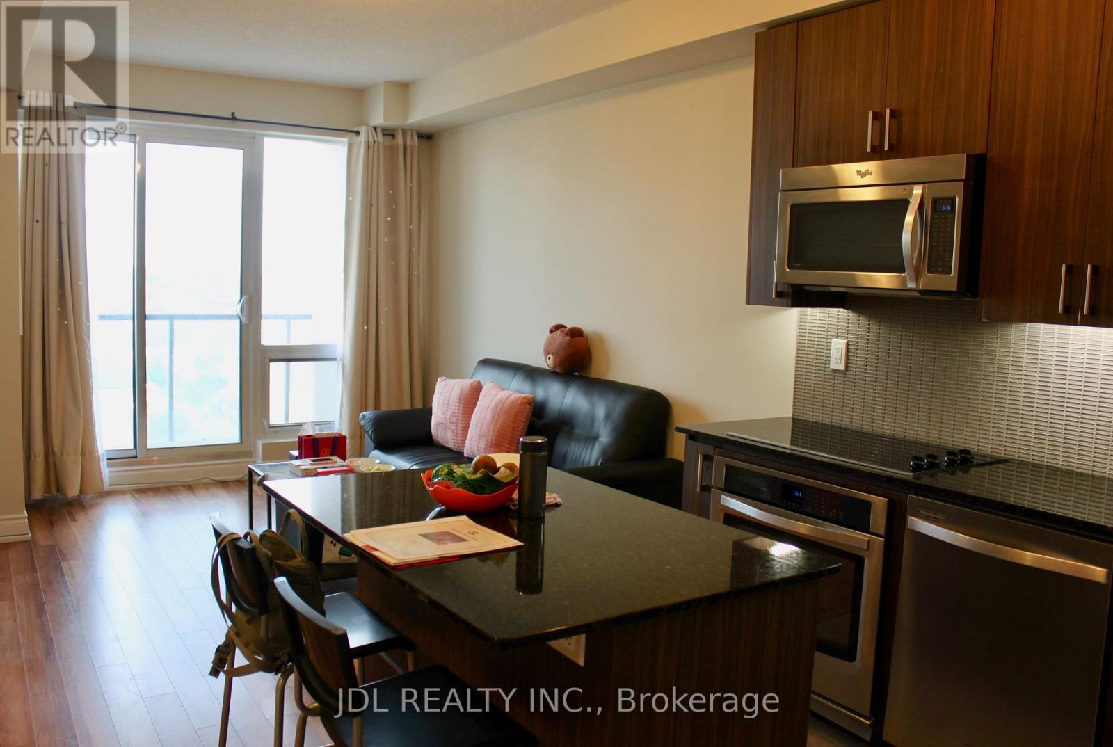 A modern kitchen with a dining table and chairs.