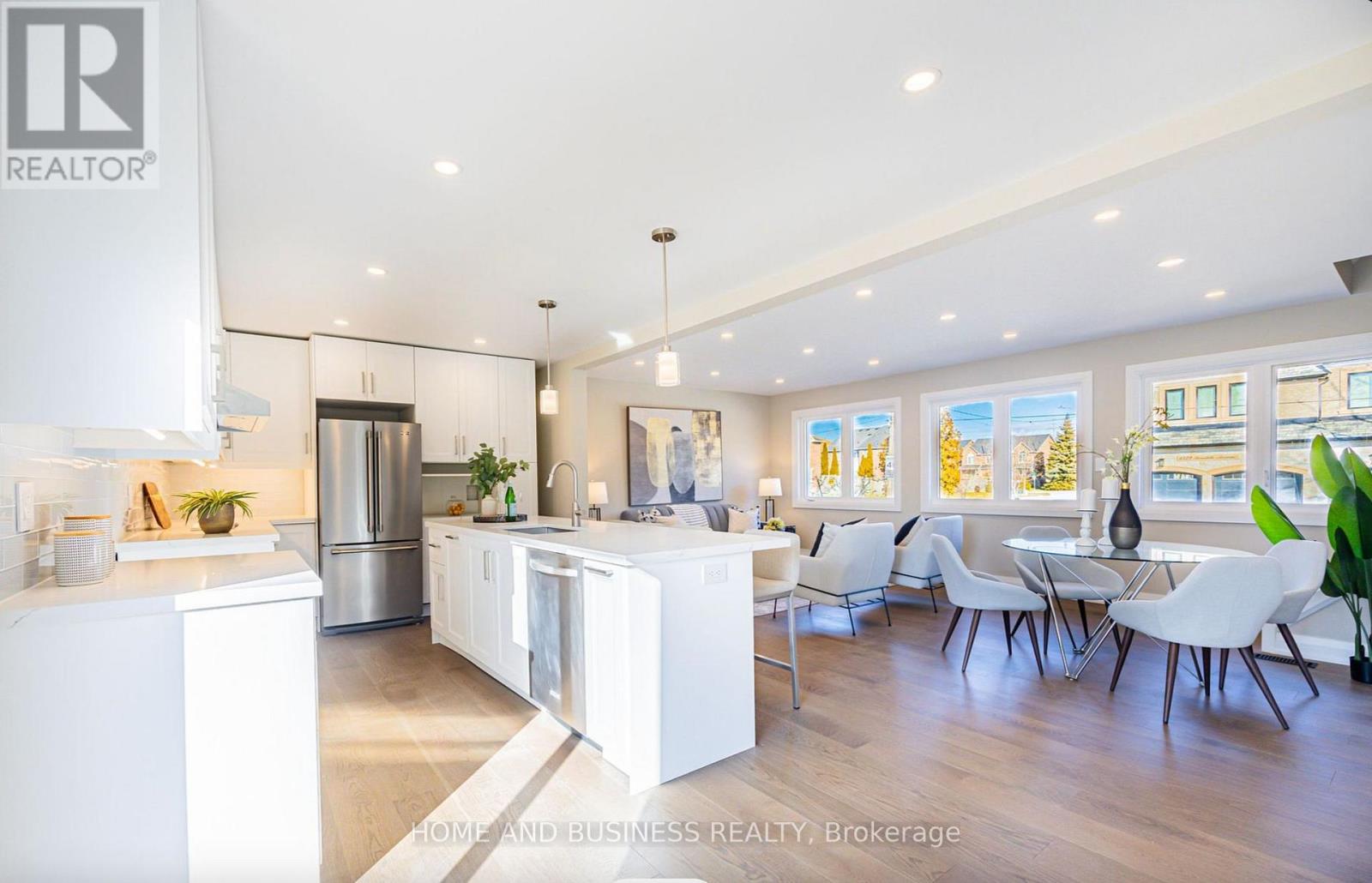 A modern kitchen with white cabinets and a large island.