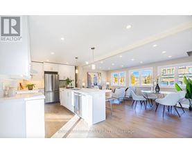 A modern kitchen with white cabinets and a large island.