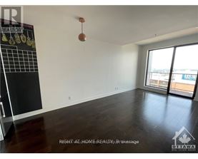 A room with a blackboard and a window overlooking a balcony.