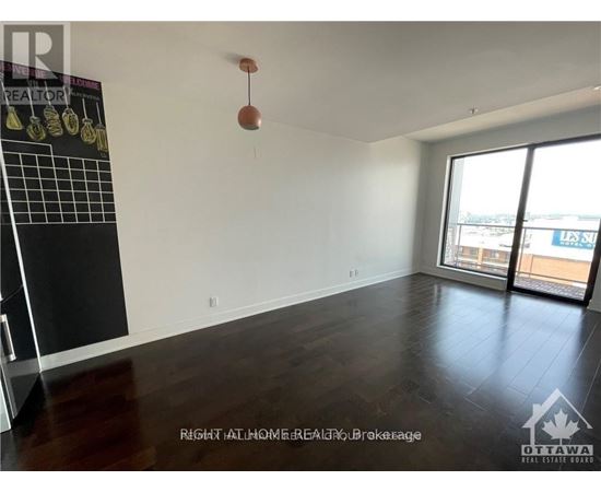 A room with a blackboard and a window overlooking a balcony.
