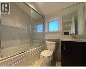 A bathroom with a toilet, sink, and bathtub.