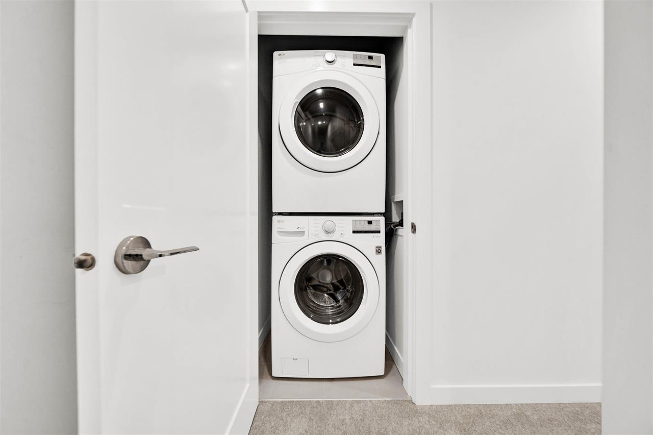 A white door with a washing machine in the other side.