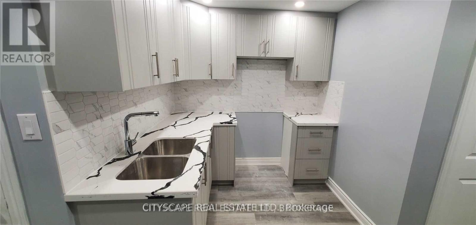 A kitchen with a sink and cabinets.