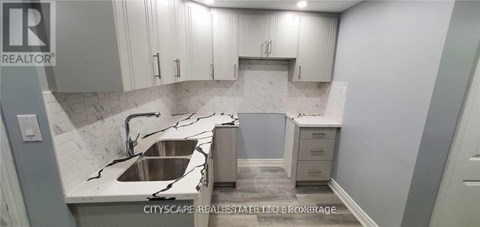 A kitchen with a sink and cabinets.
