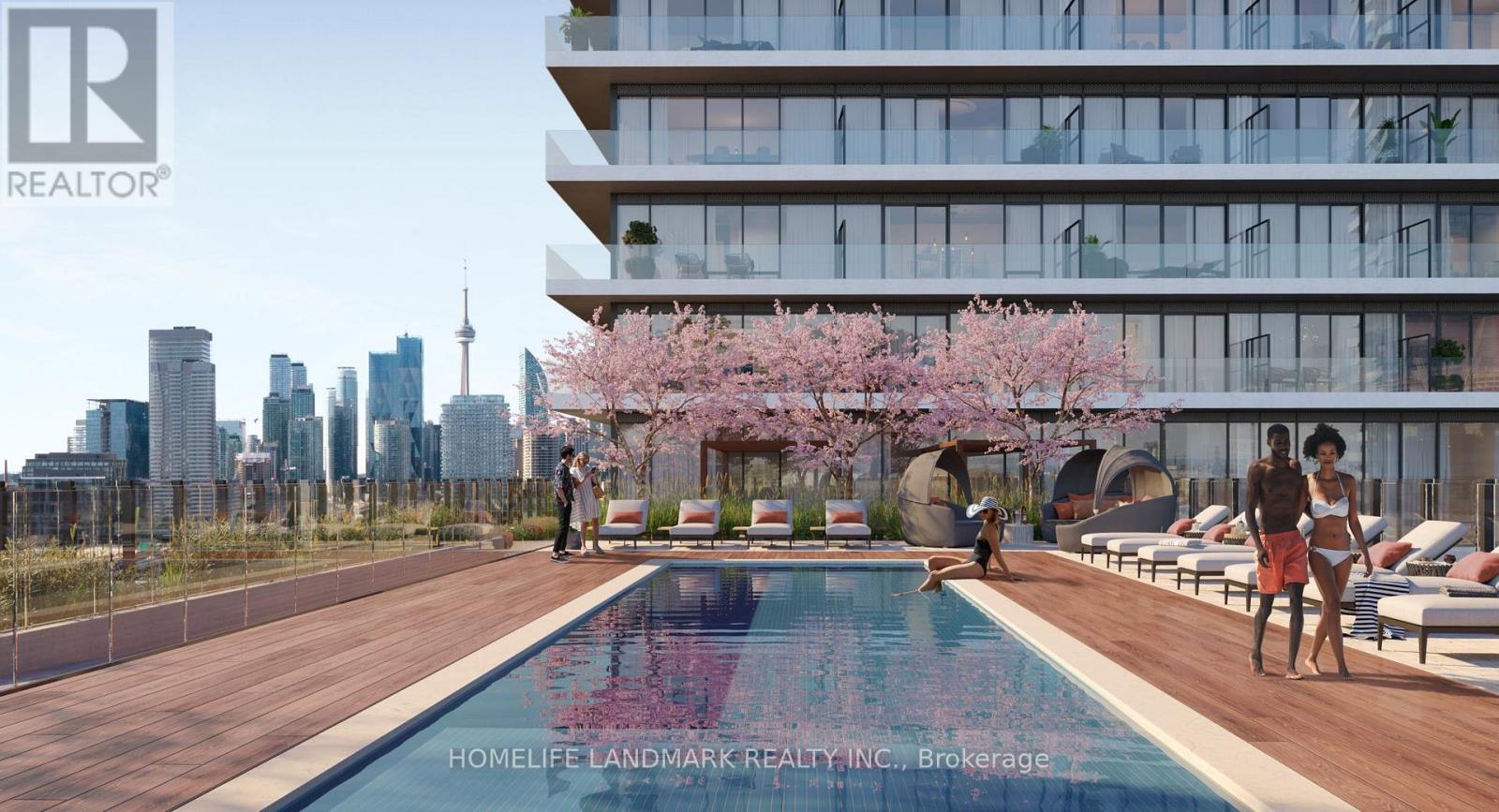 A swimming pool with people relaxing by it in front of a building.