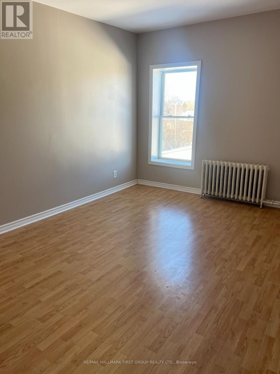 A room with a window and a radiator on the floor.