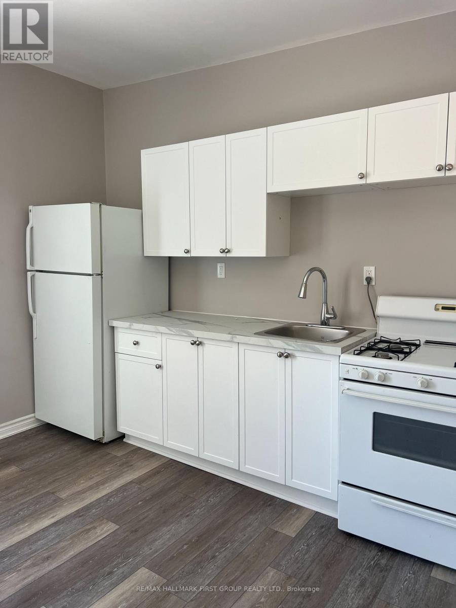 A kitchen with white appliances and cabinets.