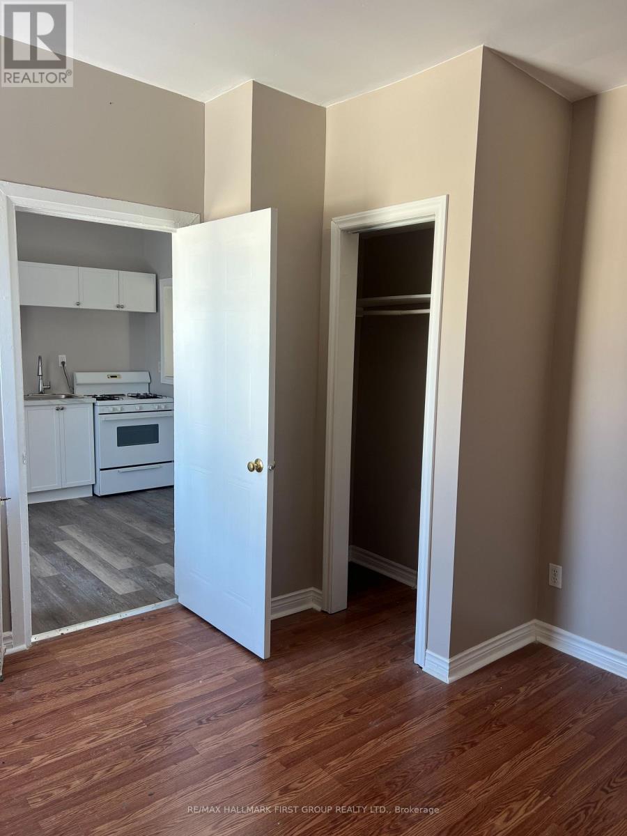 A realtor photo of a room with a doorway leading to another room.