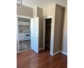 A realtor photo of a room with a doorway leading to another room.