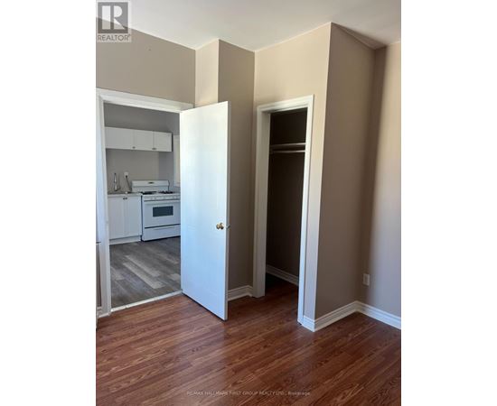 A realtor photo of a room with a doorway leading to another room.