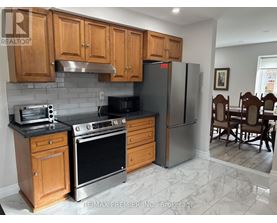 A kitchen with wooden cabinets and a black stove top oven.