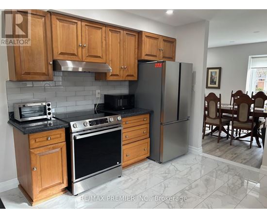 A kitchen with wooden cabinets and a black stove top oven.
