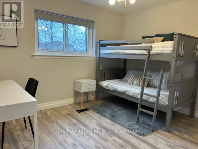 A bedroom with a bunk bed and a desk.