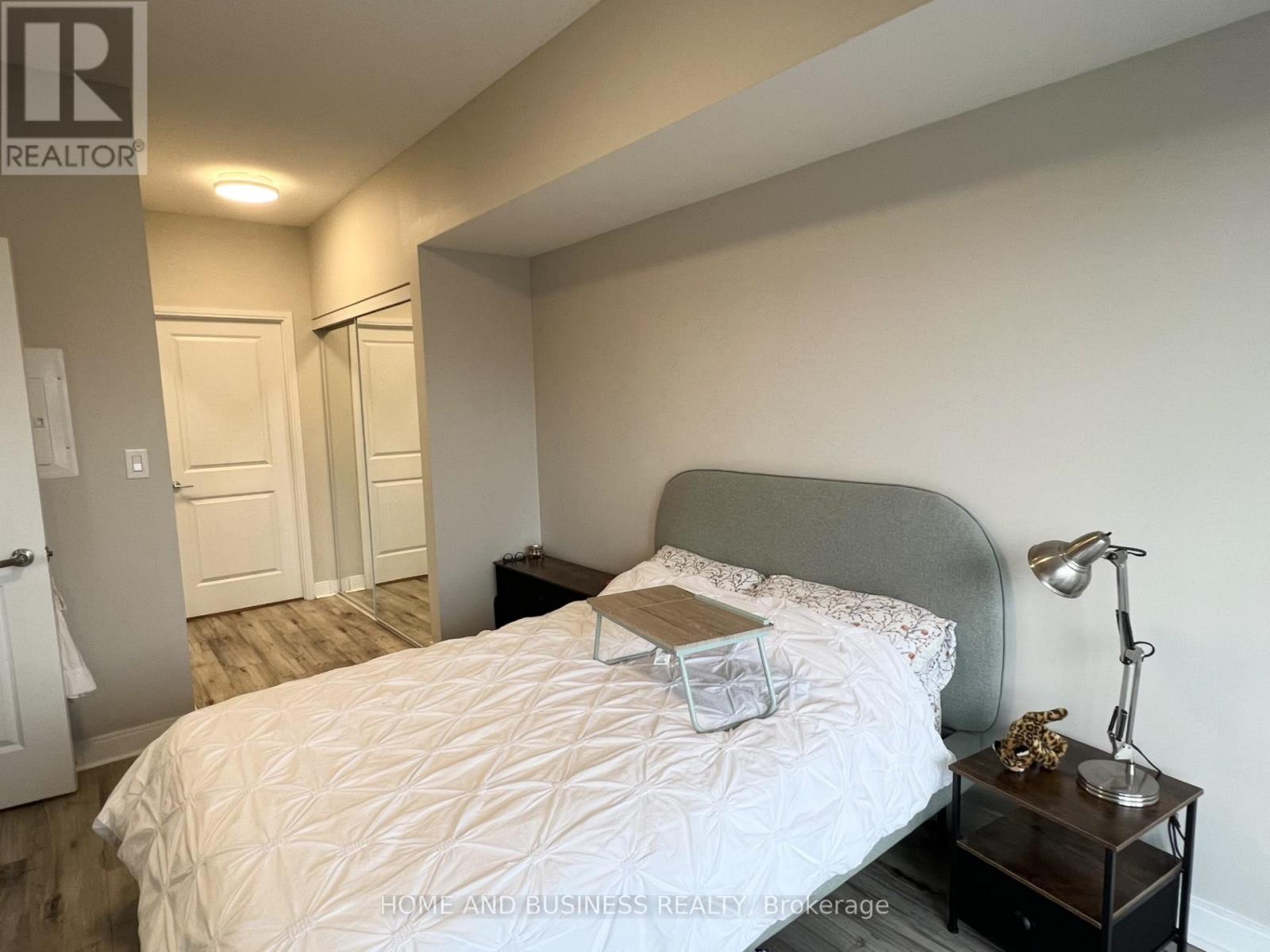 A bedroom with a large bed and a view of the city.