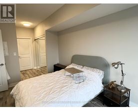 A bedroom with a large bed and a view of the city.