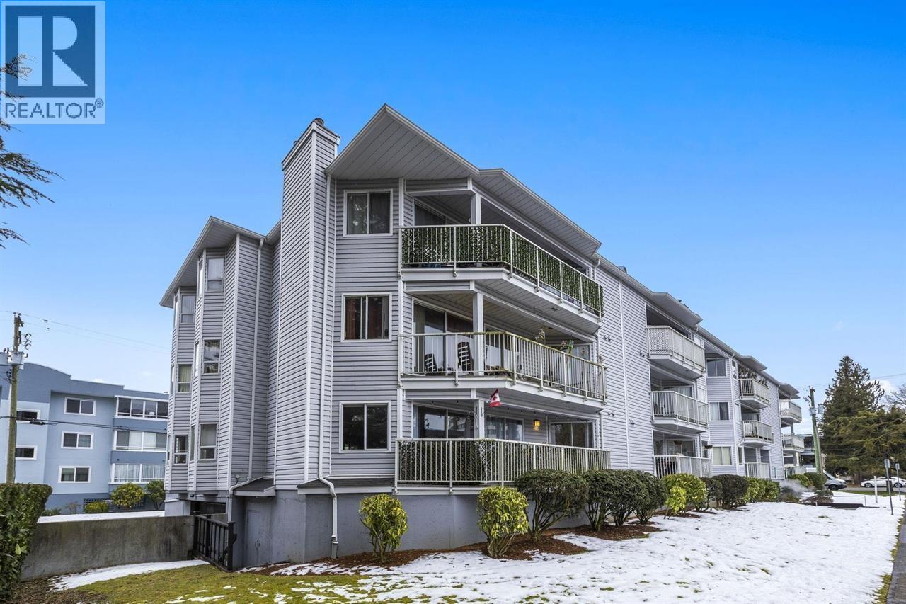 A large apartment building with a balcony on the second floor.